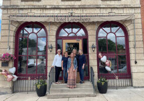 People standing on the front steps of Hotel Lanesboro